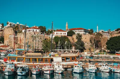Traditional wooden boats moored in Antalya's historic harbour — the picturesque old port that dental tourism patients visit during their stay on the Turkish Mediterranean coast