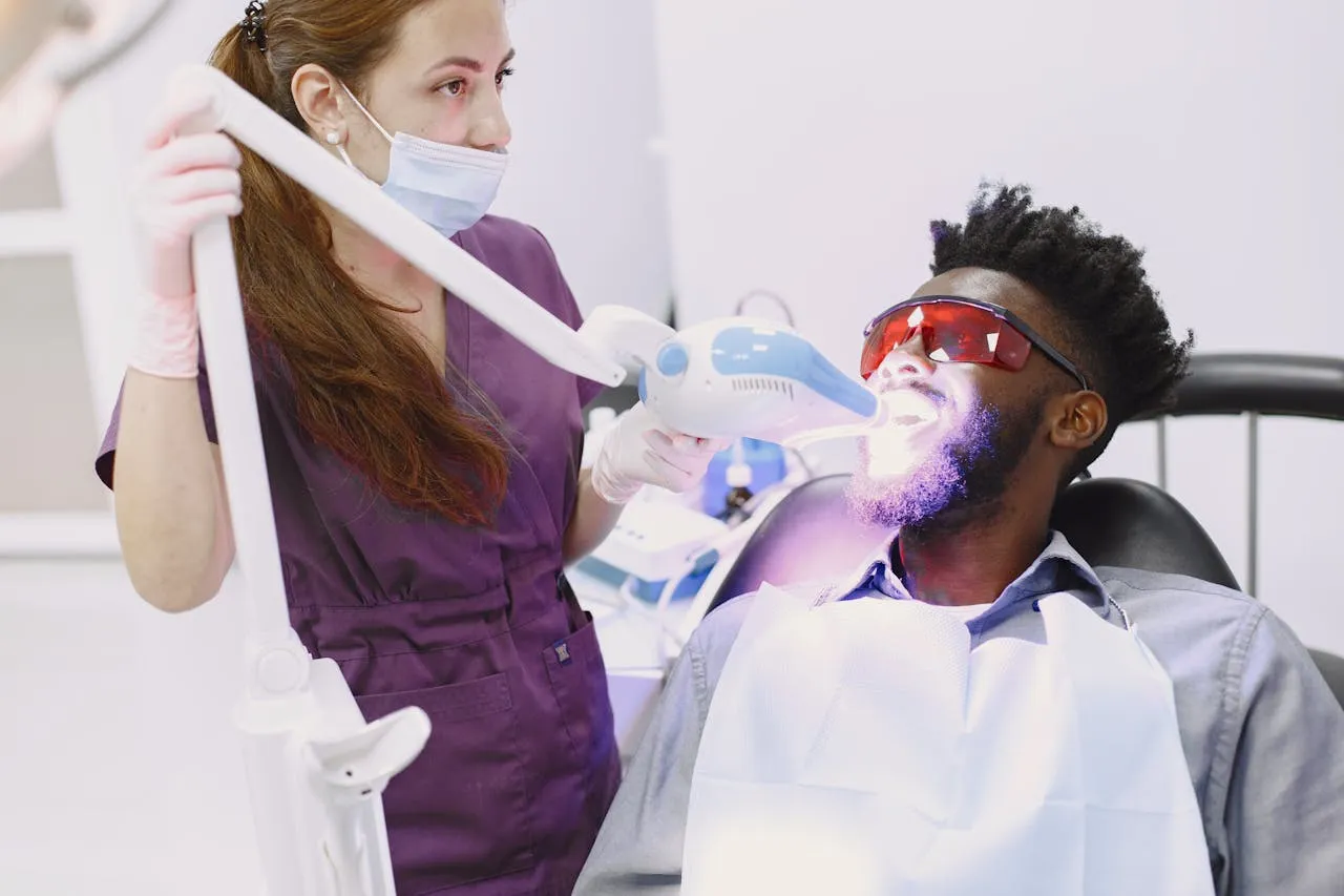 Professional teeth whitening with UV light activation at an Antalya dental clinic — in-chair Zoom whitening procedure